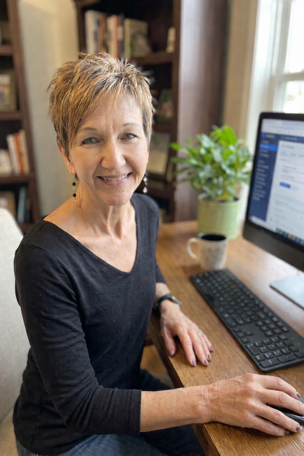 Picture of web developer Sally Sutton sitting at a desk in front of a computer